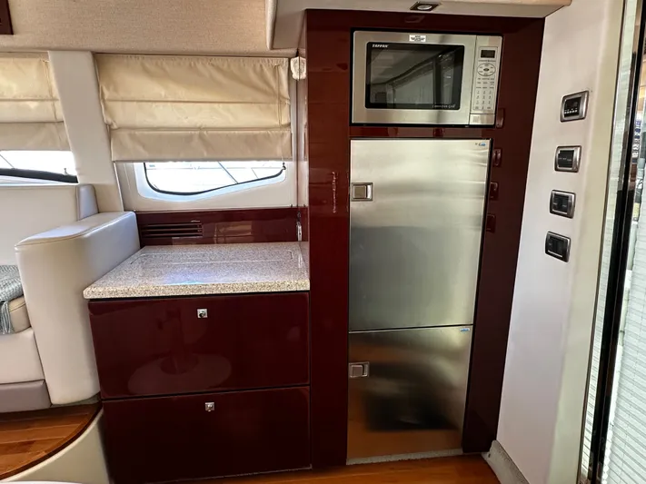 Incentive Yacht Photos Pics 2008 Sea Ray 47 Sedan Bridge interior with microwave, fridge, and elegant cabinetry.