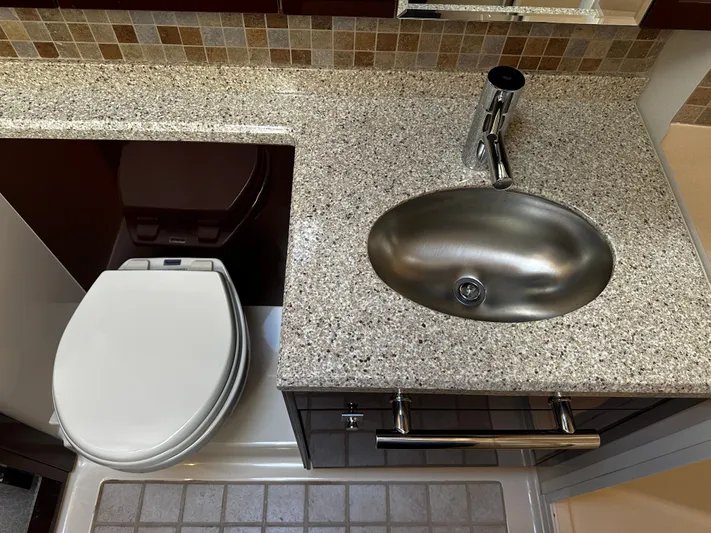 Incentive Yacht Photos Pics 2008 Sea Ray 47 Sedan Bridge bathroom with granite countertop, stainless steel sink, and modern fixtures.