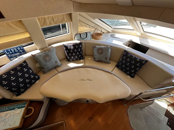 Incentive Yacht Photos Pics Luxurious interior of 2008 Sea Ray 47 Sedan Bridge with nautical-themed cushions and elegant seating.