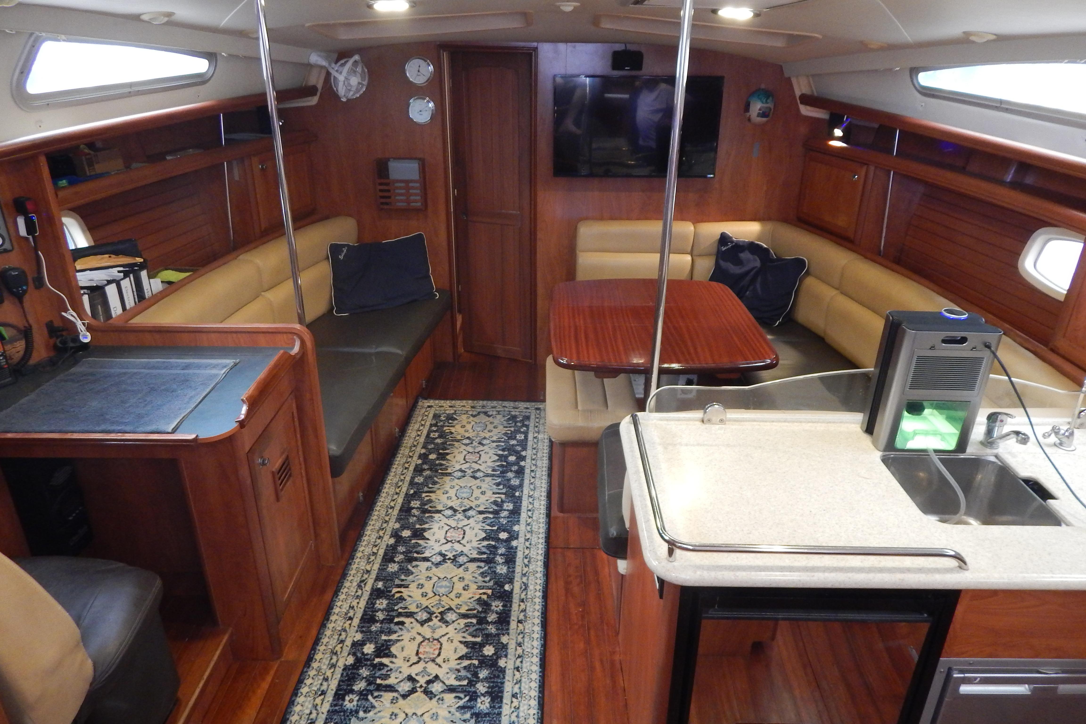 Luxurious interior of 2010 Hunter Sailing Diver yacht with wood finishes and modern amenities.