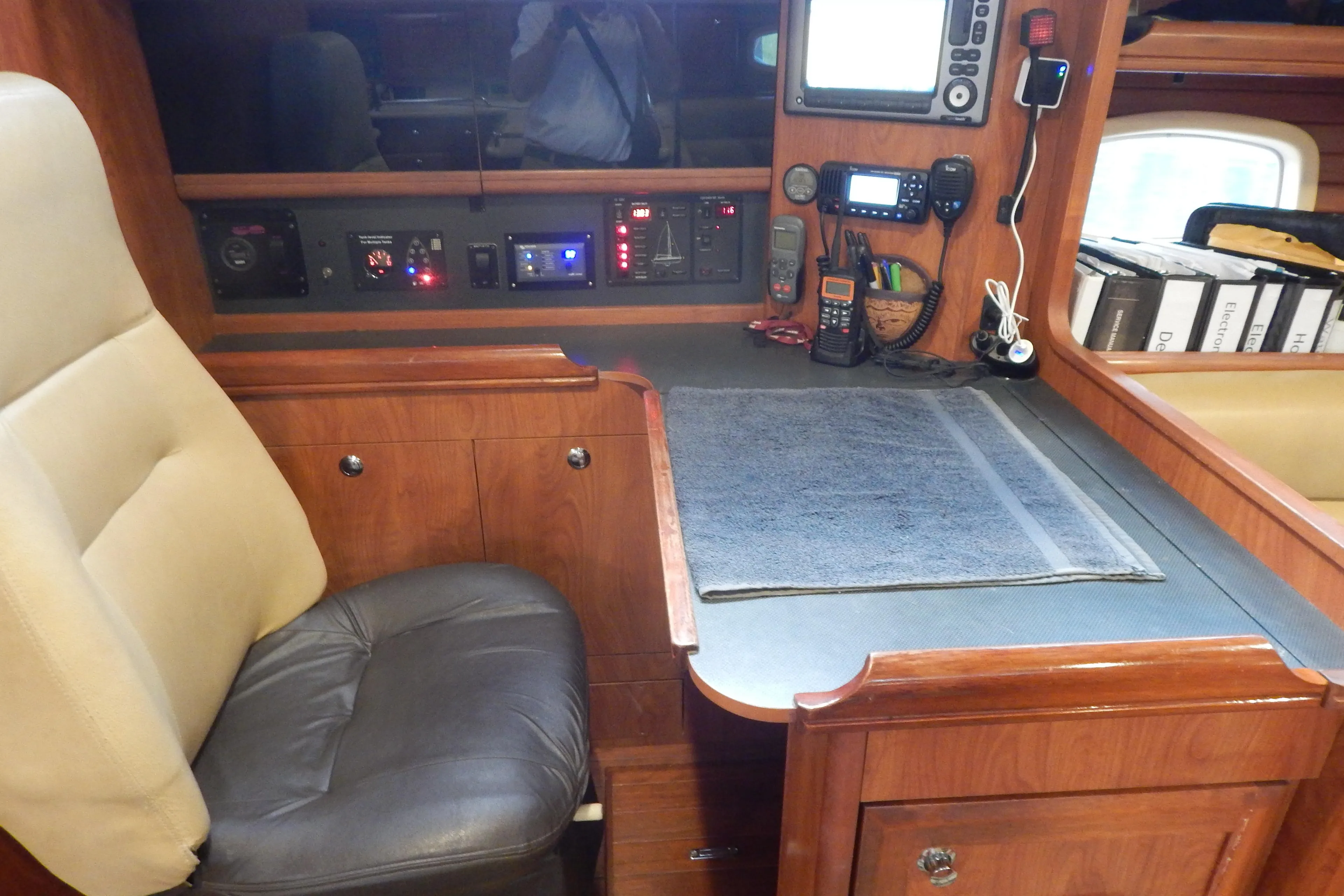 Navigation station in 2010 Hunter Sailing Diver yacht with control panels and seating.