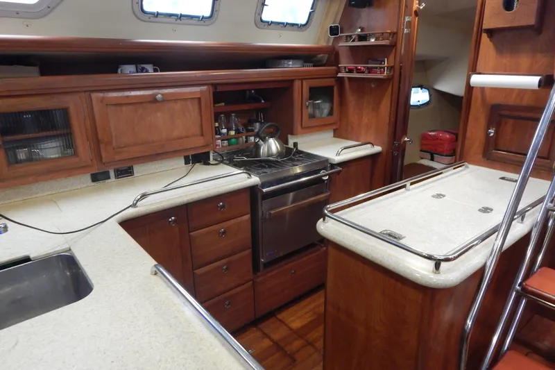  Yacht Photos Pics 2010 Hunter Sailing Diver yacht kitchen with wooden cabinets and modern appliances.