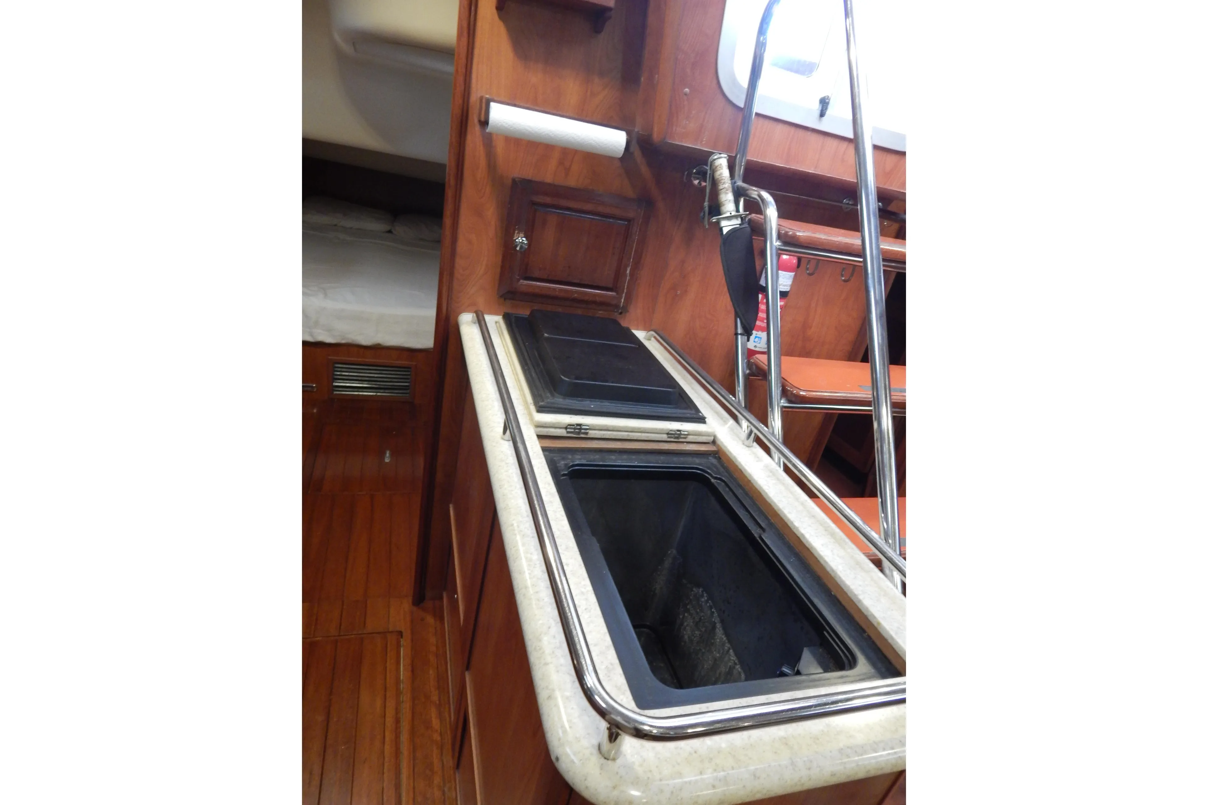 Interior of 2010 Hunter Sailing Diver yacht with wooden cabinetry and stainless steel fixtures.