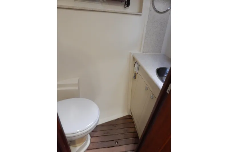  Yacht Photos Pics 2010 Hunter Sailing Diver bathroom with toilet, sink, and wooden floor.