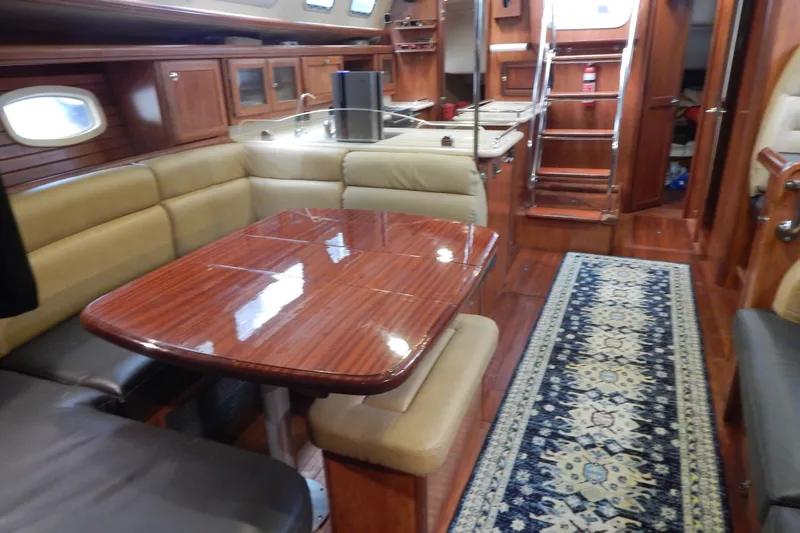 Yacht Photos Pics Luxurious interior of 2010 Hunter Sailing Diver yacht with polished wood table and elegant seating.