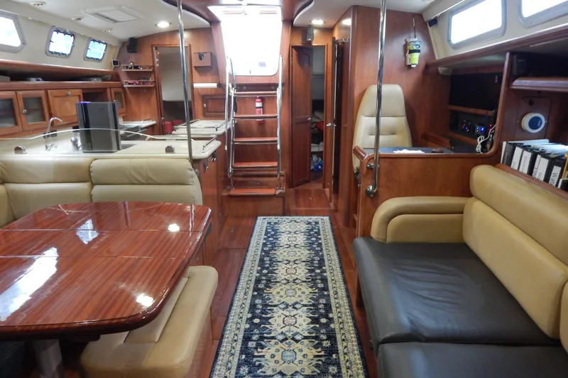  Yacht Photos Pics Luxurious interior of 2010 Hunter Sailing Diver yacht with wood finishes and comfortable seating.