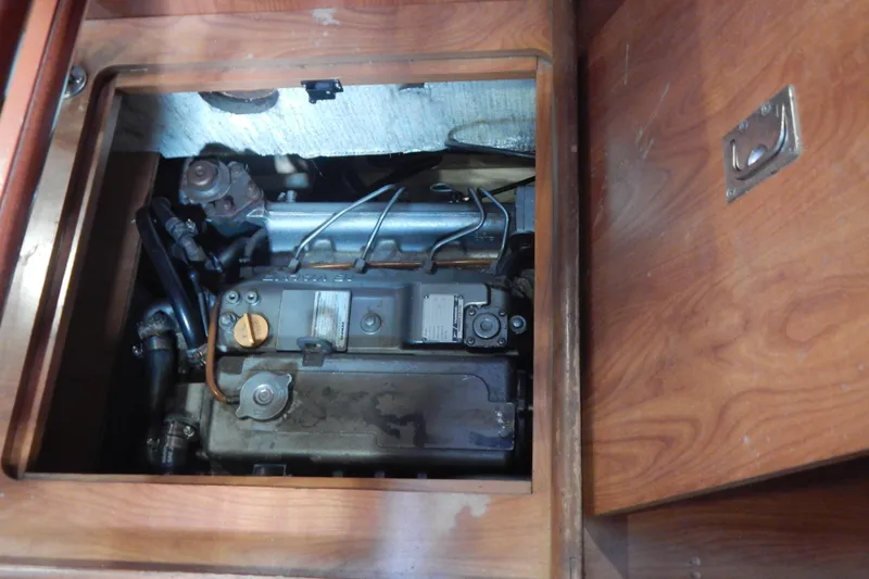  Yacht Photos Pics Engine compartment of 2010 Hunter Sailing Diver, showcasing mechanical components and wooden paneling.