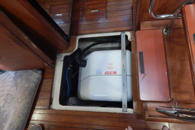  Yacht Photos Pics Engine compartment of 2010 Hunter Sailing Diver with wooden flooring and visible machinery.