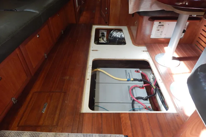  Yacht Photos Pics Interior of 2010 Hunter Sailing Diver showing battery compartment under wooden floor.