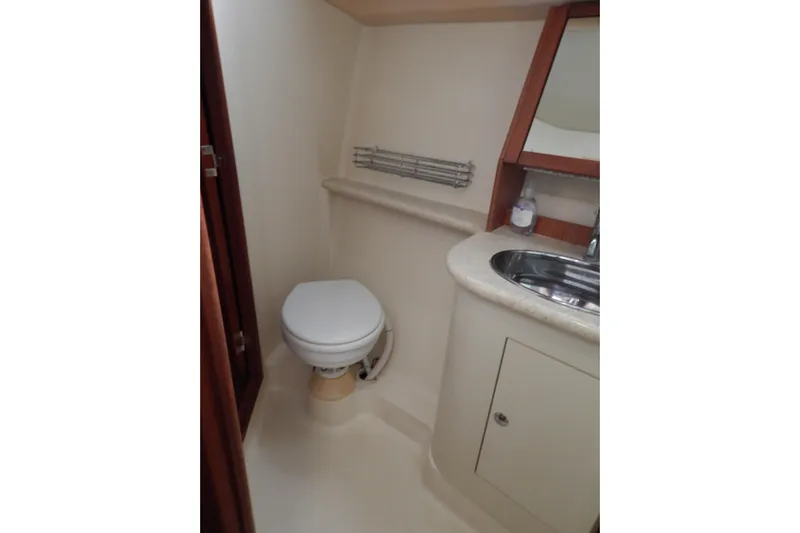  Yacht Photos Pics Compact bathroom in 2010 Hunter Sailing Diver yacht, featuring toilet and sink.