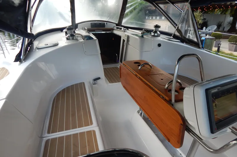  Yacht Photos Pics 2010 Hunter Sailing Diver cockpit with wooden accents and modern navigation equipment.