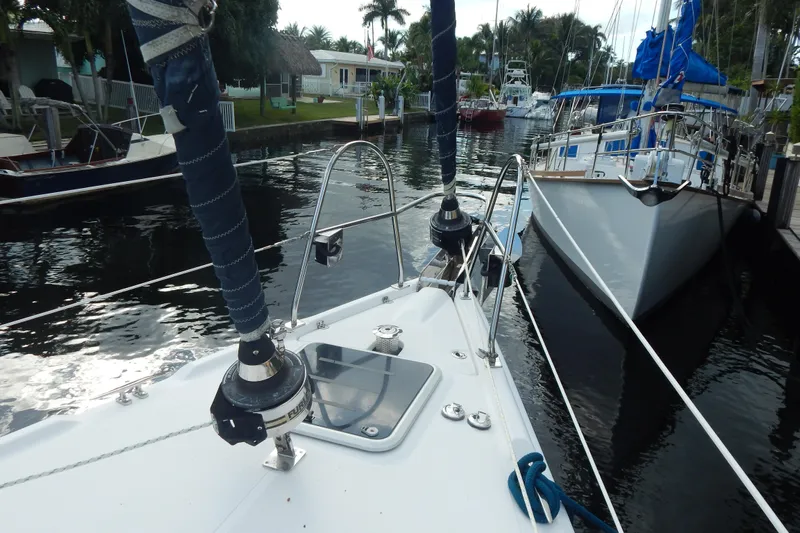  Yacht Photos Pics Hunter Sailing Diver 2010 docked in a serene marina with surrounding boats.