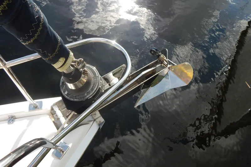  Yacht Photos Pics Anchor and winch on 2010 Hunter Sailing Diver yacht, reflecting on water.