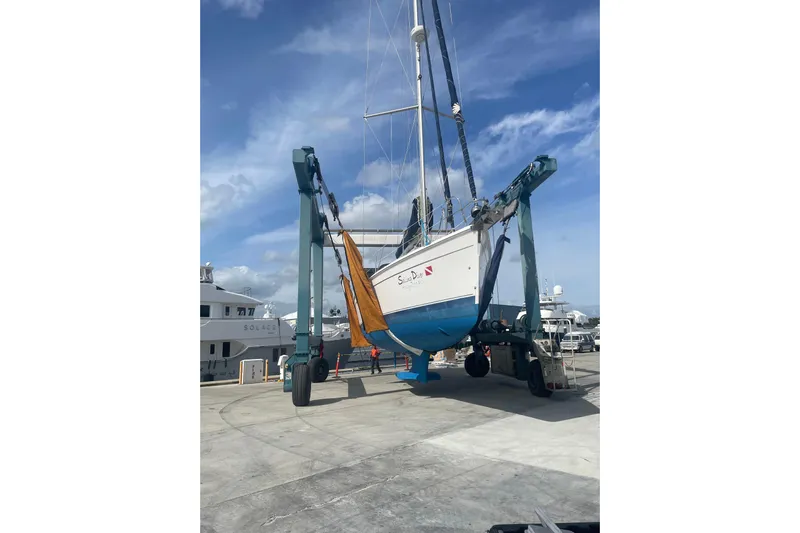  Yacht Photos Pics Hunter Sailing Diver 2010 sailboat lifted by crane at marina under blue sky.