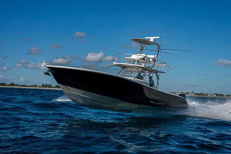  Yacht Photos Pics 2010 Yellowfin 42 Offshore boat cruising on open water under clear blue sky.