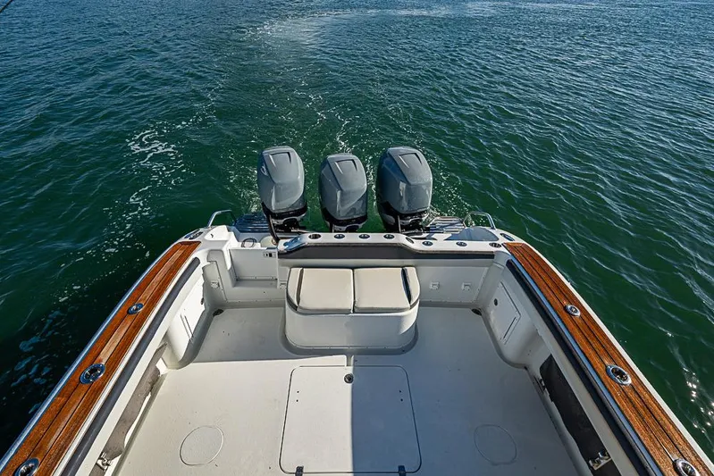  Yacht Photos Pics 2010 Yellowfin 42 Offshore boat with triple outboard motors on open water.