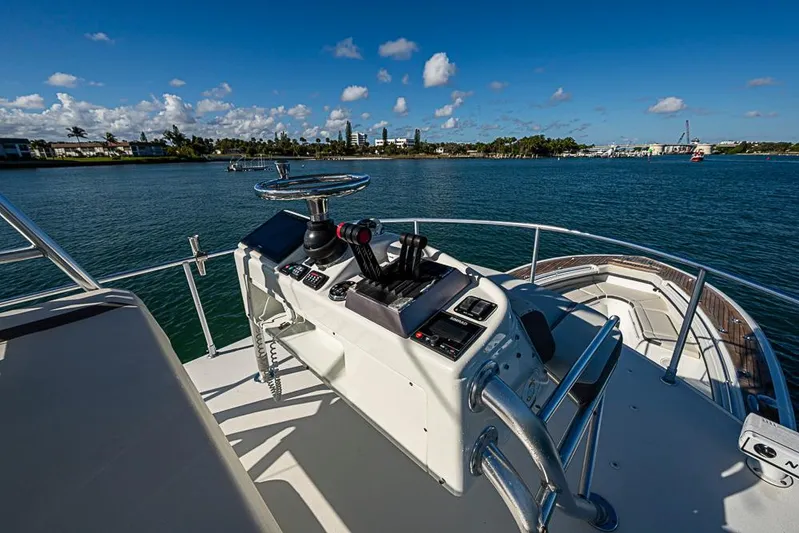  Yacht Photos Pics 2010 Yellowfin 42 Offshore boat helm with scenic waterfront view.