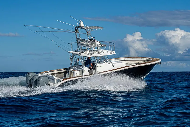  Yacht Photos Pics 2010 Yellowfin 42 Offshore boat cruising on open ocean under clear blue sky.