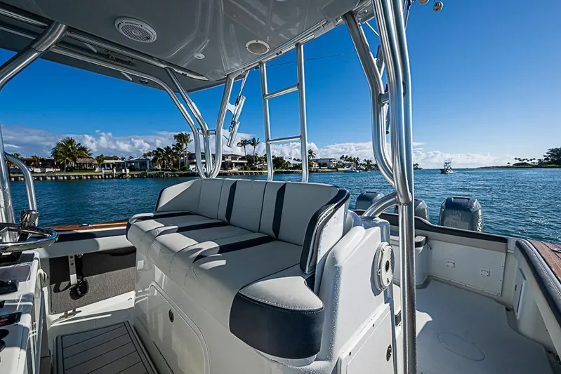  Yacht Photos Pics 2010 Yellowfin 42 Offshore boat interior with seating, overlooking serene waterfront view.