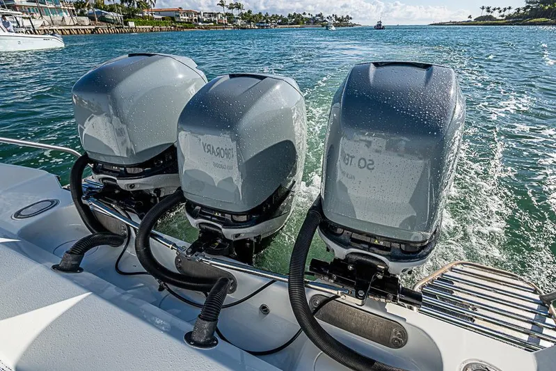  Yacht Photos Pics Triple outboard motors on a 2010 Yellowfin 42 Offshore boat in open water.