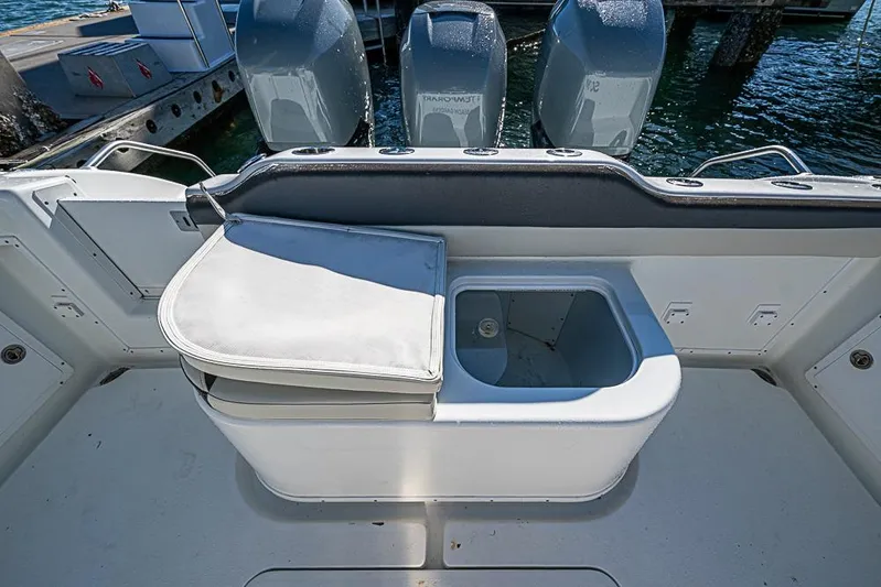  Yacht Photos Pics 2010 Yellowfin 42 Offshore boat with open storage compartment and three outboard motors.