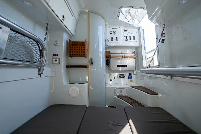  Yacht Photos Pics Interior of a 2010 Yellowfin 42 Offshore boat, featuring seating and control panels.