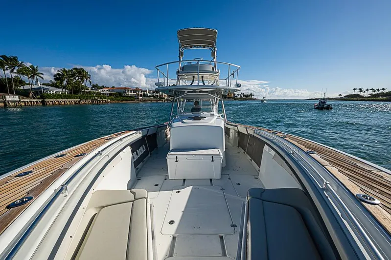  Yacht Photos Pics 2010 Yellowfin 42 Offshore boat cruising on a sunny day with clear blue skies.