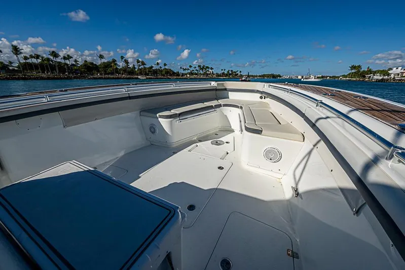  Yacht Photos Pics 2010 Yellowfin 42 Offshore boat deck with seating, under clear blue sky.