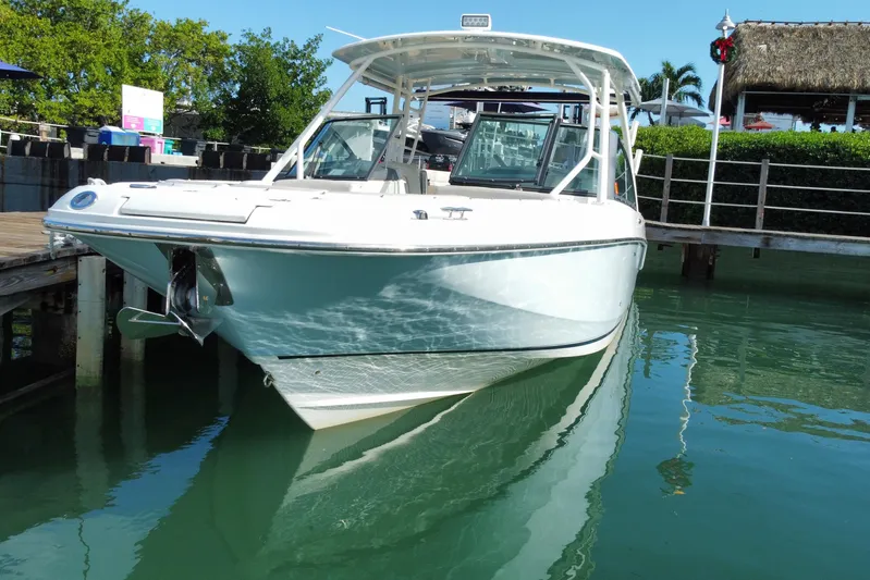  Yacht Photos Pics 2019 Boston Whaler 270 Vantage boat docked in clear water, sunny day.