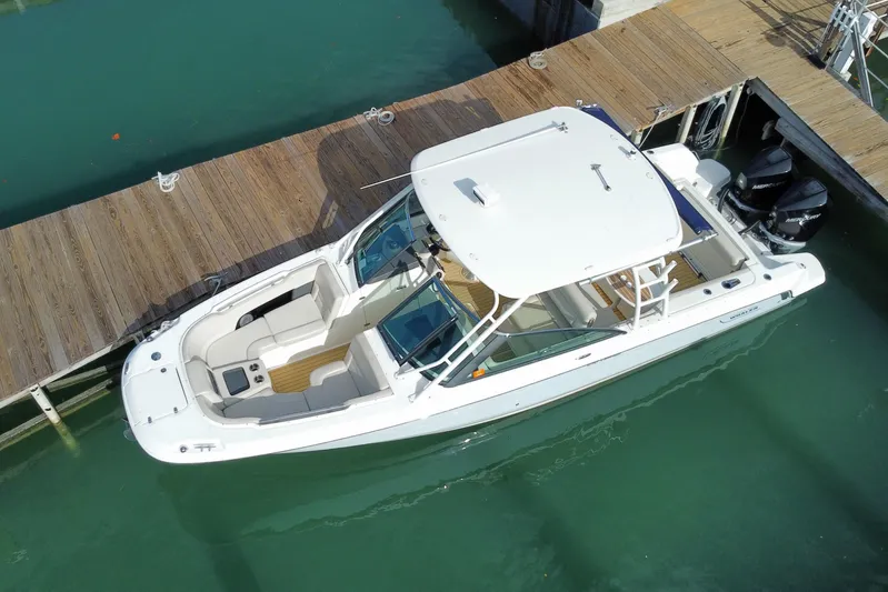  Yacht Photos Pics 2019 Boston Whaler 270 Vantage docked in clear water, aerial view.