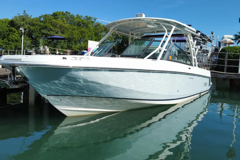  Yacht Photos Pics 2019 Boston Whaler 270 Vantage boat docked on calm water.