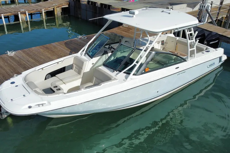  Yacht Photos Pics 2019 Boston Whaler 270 Vantage boat docked in clear water.