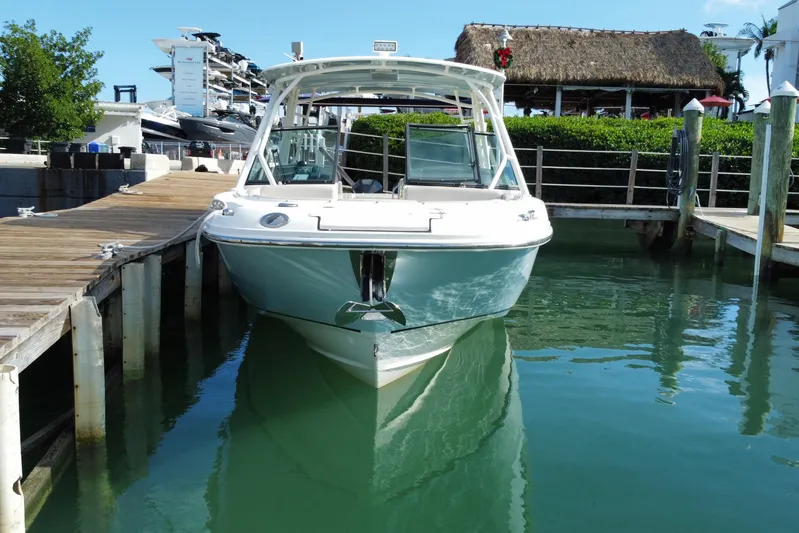  Yacht Photos Pics 2019 Boston Whaler 270 Vantage docked in a marina, clear water, sunny day.