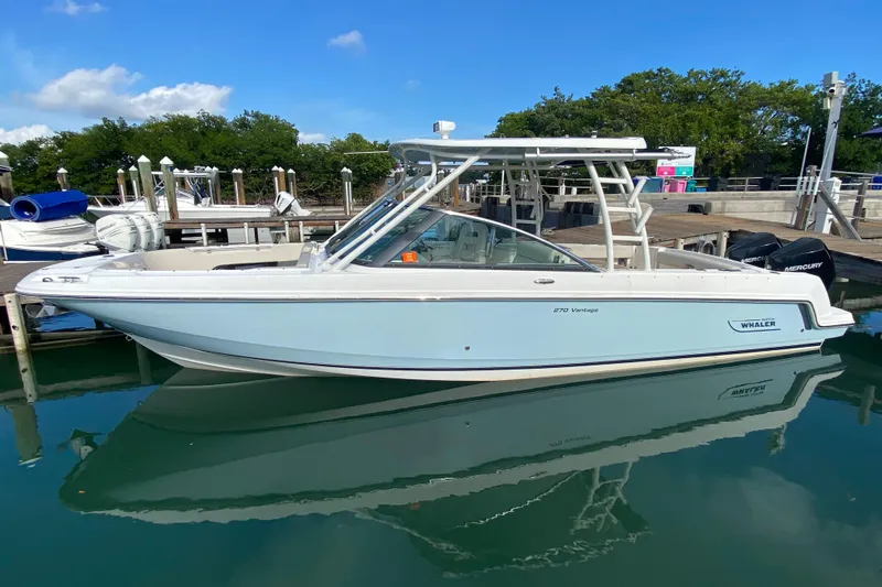  Yacht Photos Pics 2019 Boston Whaler 270 Vantage boat docked in a marina, clear blue sky.