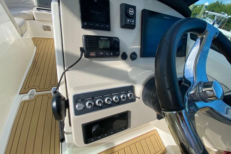  Yacht Photos Pics 2019 Boston Whaler 270 Vantage helm with steering wheel and control panel.