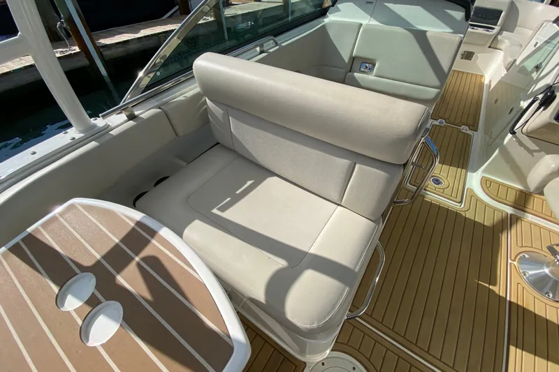  Yacht Photos Pics 2019 Boston Whaler 270 Vantage interior with beige seating and wood-style flooring.