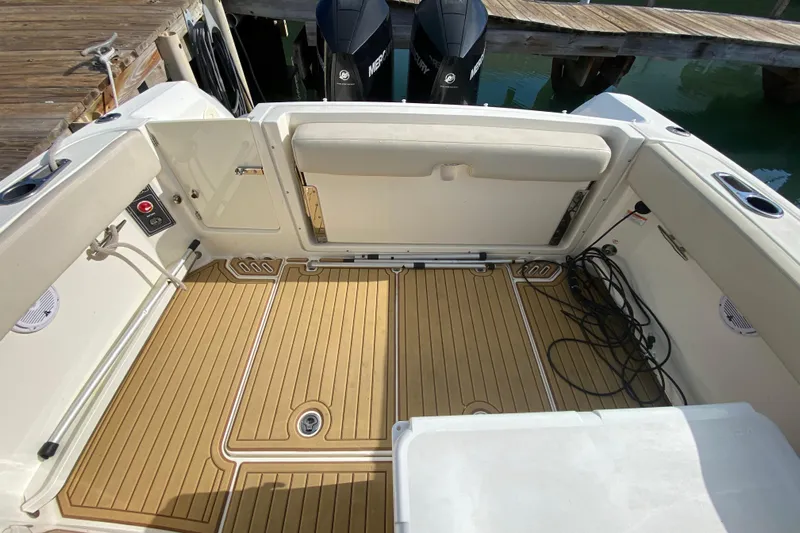  Yacht Photos Pics 2019 Boston Whaler 270 Vantage boat interior with teak flooring and dock view.