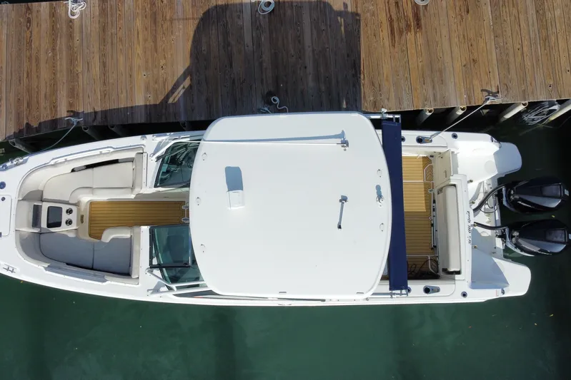  Yacht Photos Pics Overhead view of a 2019 Boston Whaler 270 Vantage docked at a wooden pier.