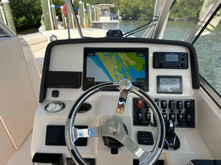  Yacht Photos Pics 2024 Grady-White Freedom 285 helm with navigation display and controls.