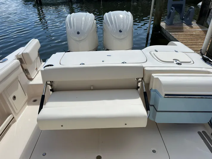  Yacht Photos Pics 2024 Grady-White Freedom 285 boat with dual engines and seating, docked by the water.