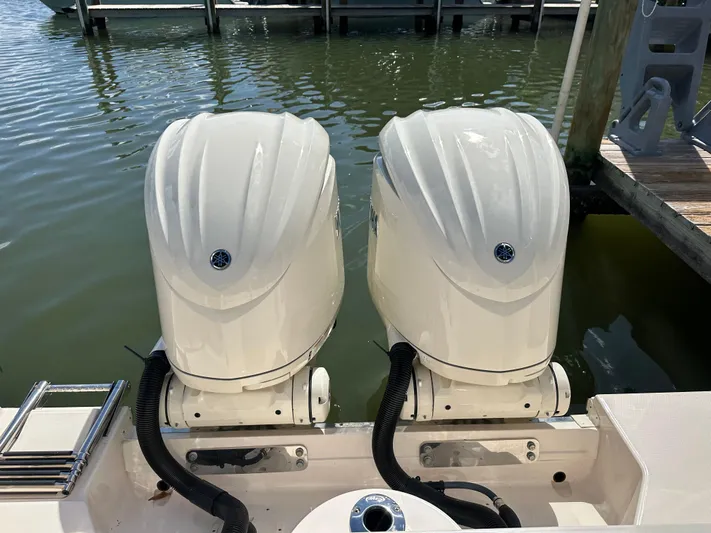  Yacht Photos Pics Twin outboard engines on a 2024 Grady-White Freedom 285 boat at a dock.