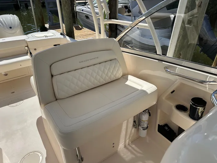  Yacht Photos Pics 2024 Grady-White Freedom 285 boat interior with cushioned seating and cup holders.