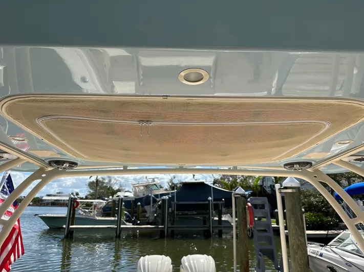  Yacht Photos Pics 2024 Grady-White Freedom 285 boat canopy with docked boats in the background.