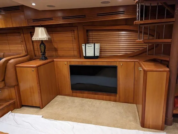  Yacht Photos Pics Interior of 2007 Hatteras 68 Convertible yacht with wooden cabinetry and spiral staircase.