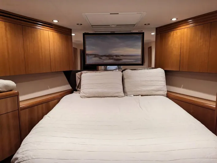  Yacht Photos Pics Luxurious bedroom in a 2007 Hatteras 68 Convertible yacht with wood cabinetry.