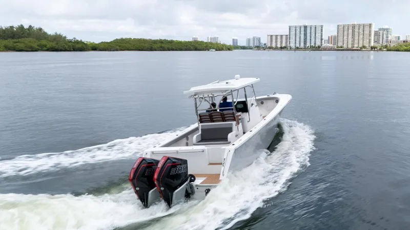 Yacht Photos Pics 2023 Seahorse 36 CC boat cruising on a calm river with city skyline.