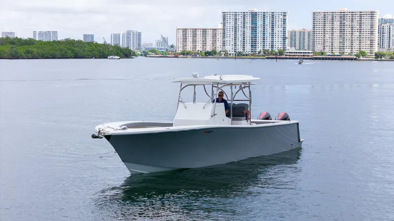  Yacht Photos Pics 2023 Seahorse 36 CC boat on calm water with city skyline background.