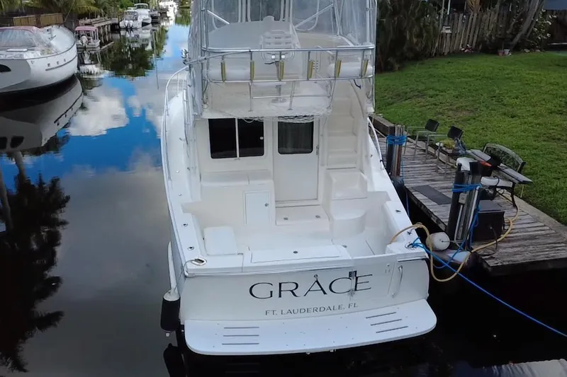  Yacht Photos Pics 2008 Luhrs 35 Convertible yacht docked in a serene canal setting.