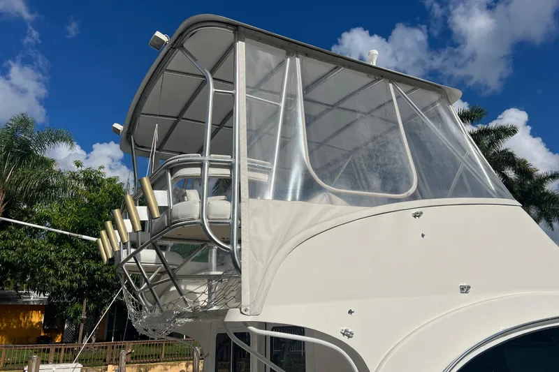  Yacht Photos Pics 2008 Luhrs 35 Convertible boat with flybridge against blue sky and palm trees.