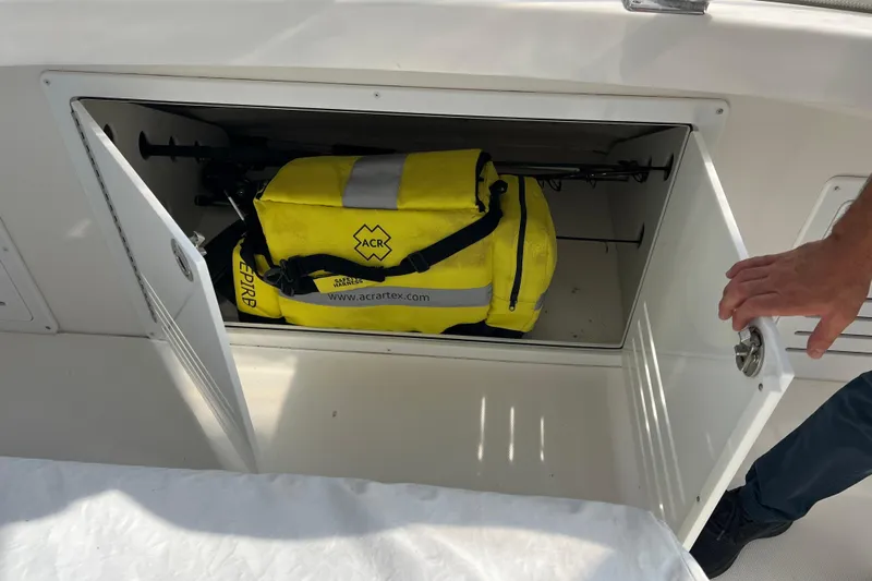  Yacht Photos Pics Storage compartment on 2008 Luhrs 35 Convertible with yellow ACR emergency bag.